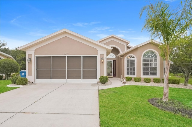 11741 Teapot Ct, Spring Hill, FL 34609 - single story home featuring driveway, a front lawn, a garage, and stucco siding