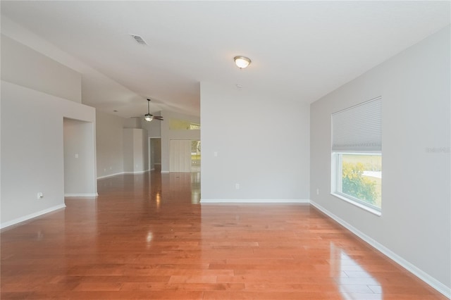 11741 Teapot Ct, Spring Hill, FL 34609 - empty room with light wood-style flooring, lofted ceiling, a ceiling fan, and baseboards