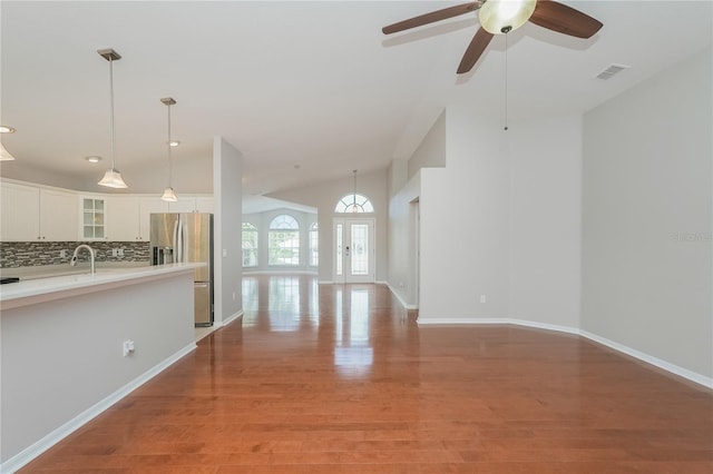 11741 Teapot Ct, Spring Hill, FL 34609 - unfurnished living room featuring light wood-type flooring, a ceiling fan, lofted ceiling, baseboards, and recessed lighting
