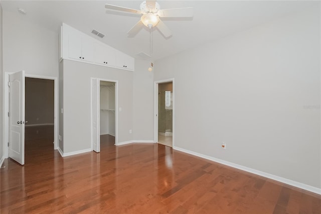 11741 Teapot Ct, Spring Hill, FL 34609 - unfurnished bedroom with high vaulted ceiling, baseboards, a walk in closet, wood finished floors, and a closet