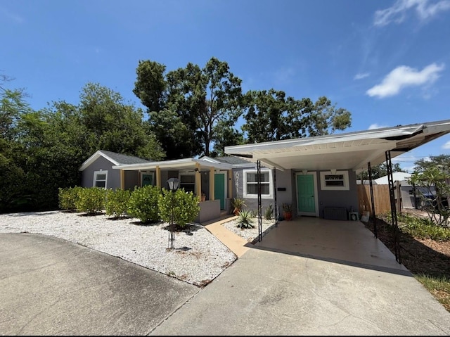 6741 4th Ave N, Saint Petersburg, FL 33710 - view of front of house with driveway, an attached carport, and stucco siding