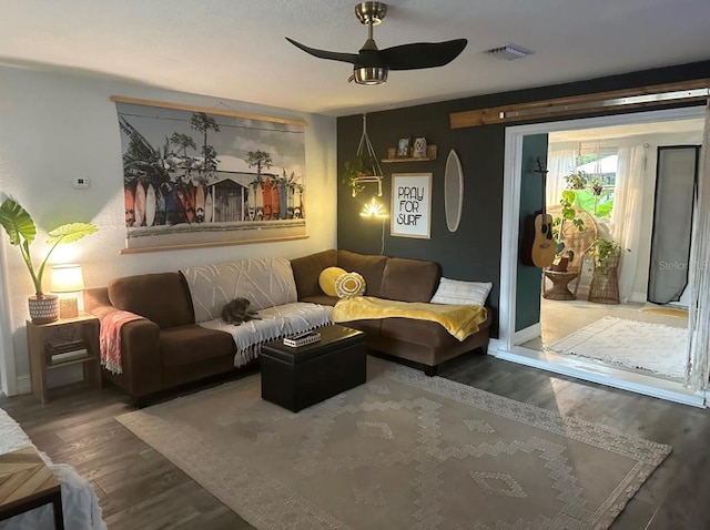 6741 4th Ave N, Saint Petersburg, FL 33710 - living room featuring wood finished floors, ceiling fan, and baseboards