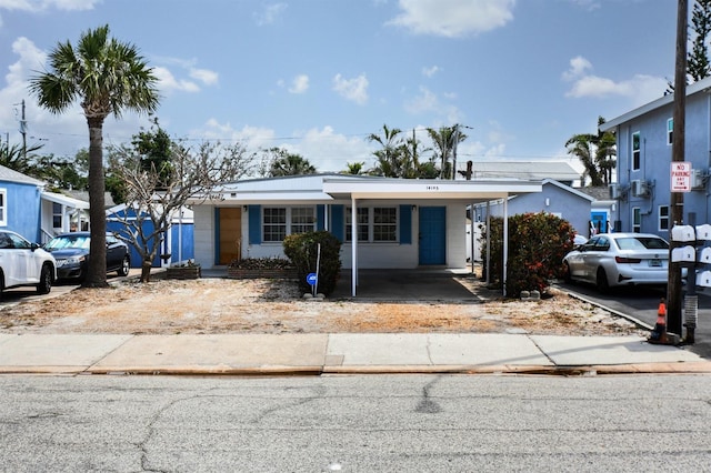 14147 Palm St, Madeira Beach, FL 33708 - view of front of property with a carport and driveway