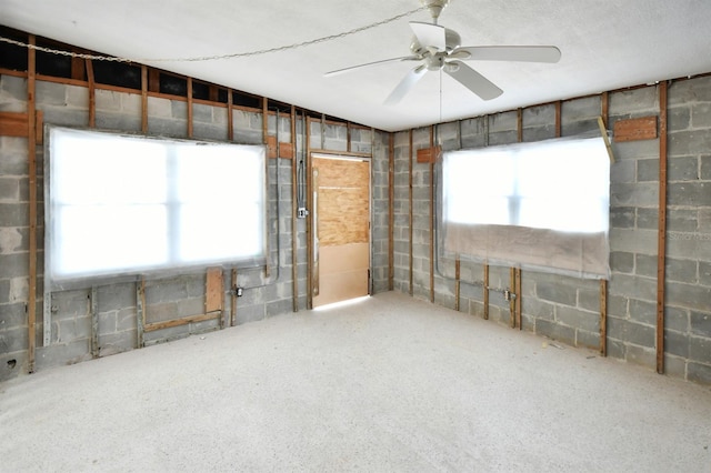 14147 Palm St, Madeira Beach, FL 33708 - empty room featuring ceiling fan and concrete block wall