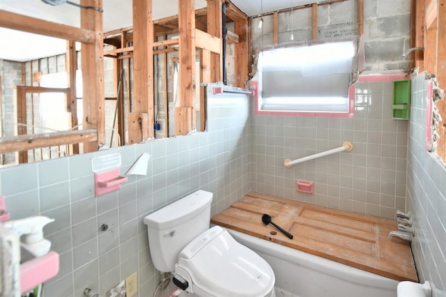 14147 Palm St, Madeira Beach, FL 33708 - full bath with toilet, a tub, and tile walls