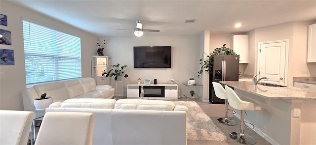 living room featuring a ceiling fan, light tile patterned floors, recessed lighting, and baseboards