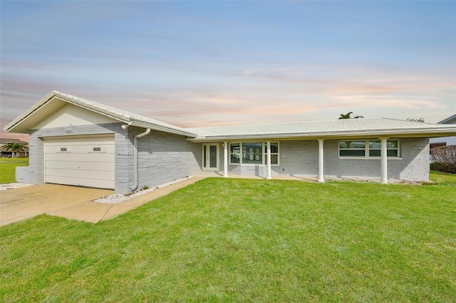 710 116th Ave, Treasure Island, FL 33706 - view of front facade with an attached garage, a yard, and concrete driveway