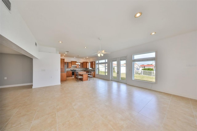 710 116th Ave, Treasure Island, FL 33706 - living room featuring a ceiling fan, recessed lighting, light tile patterned floors, and baseboards