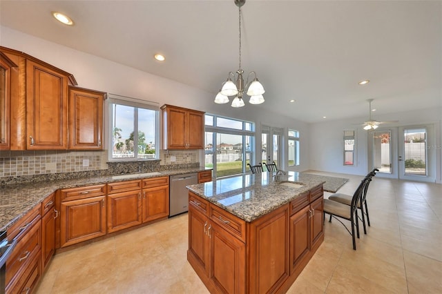 710 116th Ave, Treasure Island, FL 33706 - kitchen with dishwasher, brown cabinets, tasteful backsplash, a kitchen island, and recessed lighting