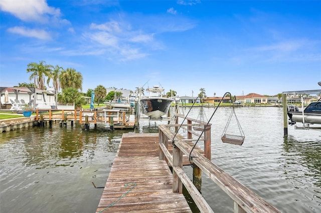 710 116th Ave, Treasure Island, FL 33706 - dock area featuring boat lift and a water view