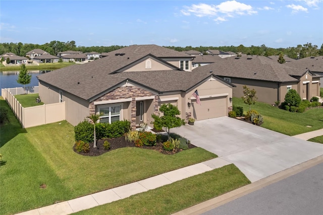 18428 Malinche Loop, Spring Hill, FL 34610 - view of front of home with a residential view, driveway, an attached garage, stucco siding, and roof with shingles