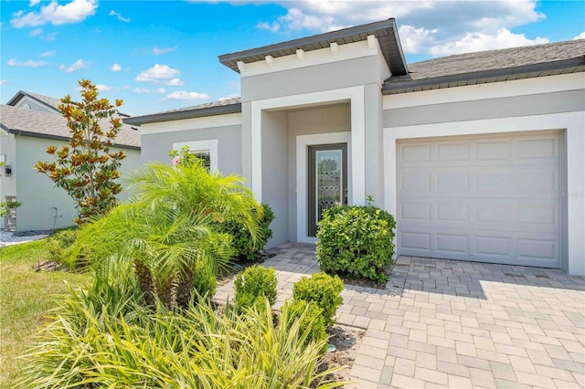 17618 Cortes Creek Blvd, Spring Hill, FL 34610 - entrance to property with an attached garage, stucco siding, and decorative driveway