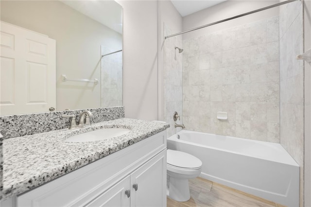 17618 Cortes Creek Blvd, Spring Hill, FL 34610 - full bathroom featuring toilet, wood finished floors, washtub / shower combination, and vanity