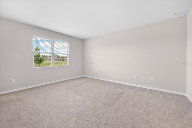 17618 Cortes Creek Blvd, Spring Hill, FL 34610 - unfurnished room with baseboards, light colored carpet, and a smoke detector