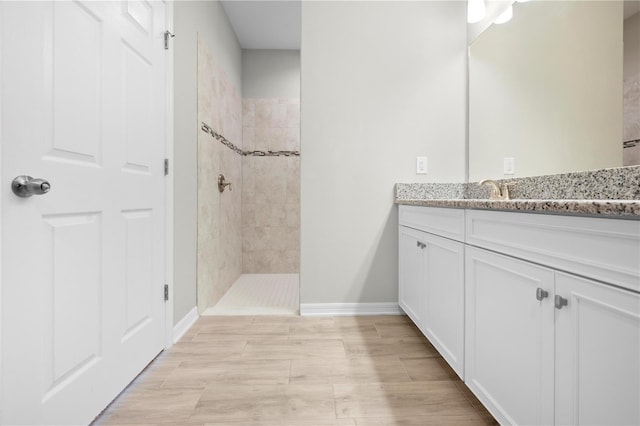 17618 Cortes Creek Blvd, Spring Hill, FL 34610 - bathroom featuring tiled shower, baseboards, and vanity