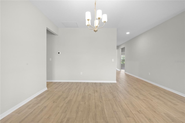 17618 Cortes Creek Blvd, Spring Hill, FL 34610 - spare room with light wood-type flooring, recessed lighting, baseboards, and a chandelier