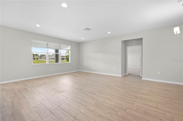 17618 Cortes Creek Blvd, Spring Hill, FL 34610 - unfurnished room featuring light wood finished floors, recessed lighting, baseboards, and a chandelier