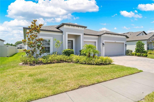 17618 Cortes Creek Blvd, Spring Hill, FL 34610 - prairie-style house with an attached garage, stucco siding, driveway, a front yard, and a shingled roof