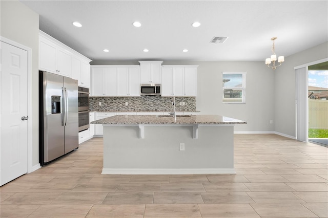 17618 Cortes Creek Blvd, Spring Hill, FL 34610 - kitchen featuring stainless steel appliances, a sink, backsplash, white cabinets, and recessed lighting