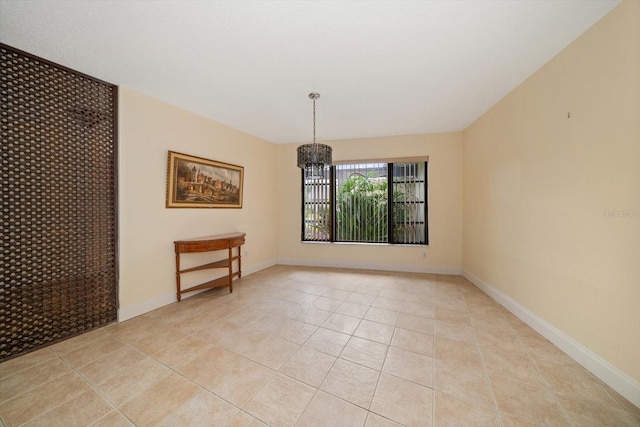 14175 Feather Sound Dr, Clearwater, FL 33762 - unfurnished room with a chandelier, light tile patterned flooring, and baseboards