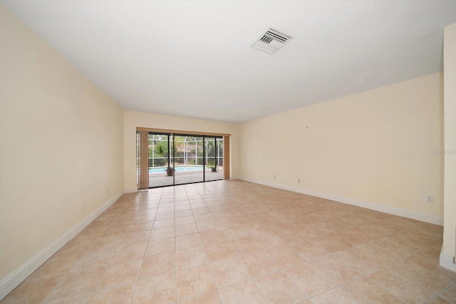 14175 Feather Sound Dr, Clearwater, FL 33762 - empty room with light tile patterned floors and baseboards
