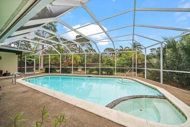 14175 Feather Sound Dr, Clearwater, FL 33762 - view of swimming pool with a pool with connected hot tub, a patio area, glass enclosure, and a fenced backyard