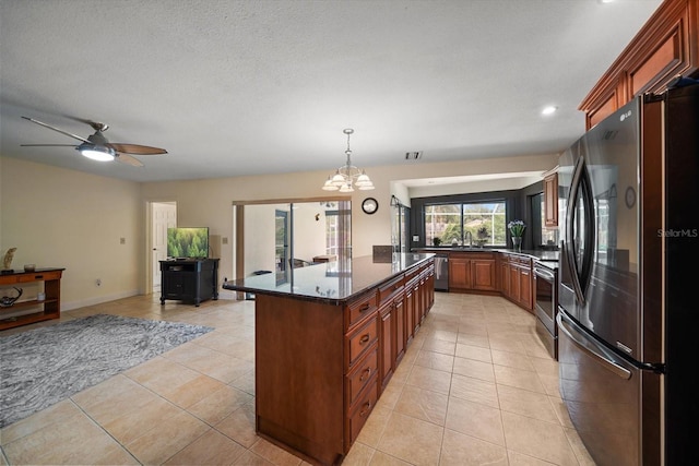 14175 Feather Sound Dr, Clearwater, FL 33762 - kitchen with appliances with stainless steel finishes, a sink, light tile patterned flooring, a chandelier, and hanging light fixtures