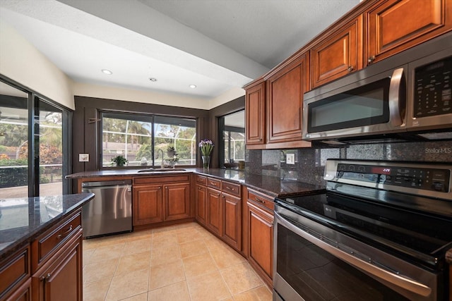 14175 Feather Sound Dr, Clearwater, FL 33762 - kitchen with stainless steel appliances, a sink, dark stone counters, light tile patterned floors, and recessed lighting