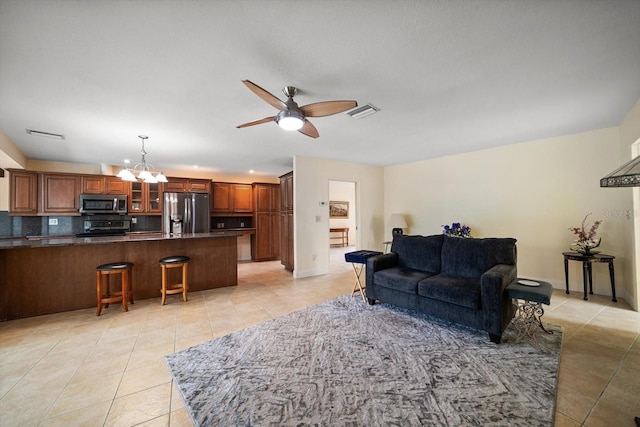 14175 Feather Sound Dr, Clearwater, FL 33762 - living room featuring light tile patterned floors, a chandelier, ceiling fan, and baseboards