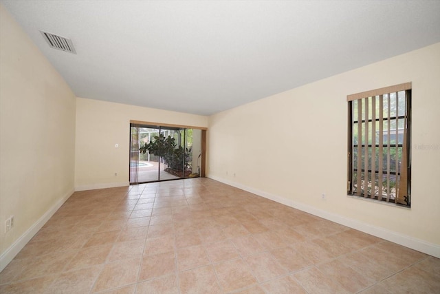 14175 Feather Sound Dr, Clearwater, FL 33762 - spare room featuring light tile patterned floors and baseboards