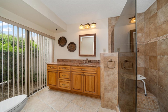 14175 Feather Sound Dr, Clearwater, FL 33762 - bathroom featuring vanity, tile patterned floors, tiled shower, and toilet