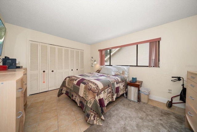 14175 Feather Sound Dr, Clearwater, FL 33762 - bedroom featuring light tile patterned floors, a closet, and baseboards