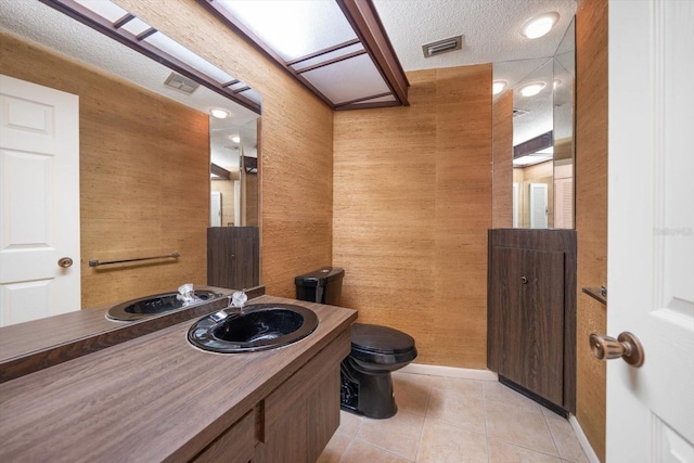 14175 Feather Sound Dr, Clearwater, FL 33762 - bathroom with toilet, vanity, tile patterned floors, baseboards, and a textured ceiling