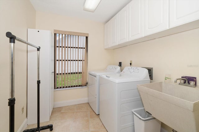 14175 Feather Sound Dr, Clearwater, FL 33762 - washroom with cabinet space, washer and dryer, baseboards, and light tile patterned floors