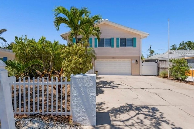 1210 Bay Pine Blvd, Indian Rocks Beach, FL 33785 - view of front of home with a garage, a gate, and concrete driveway