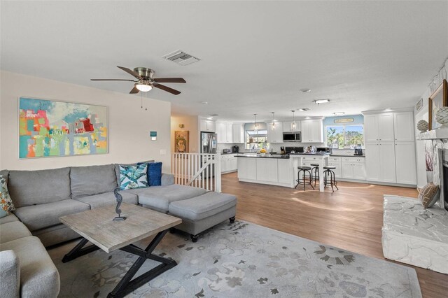 1210 Bay Pine Blvd, Indian Rocks Beach, FL 33785 - living room with light wood finished floors and ceiling fan