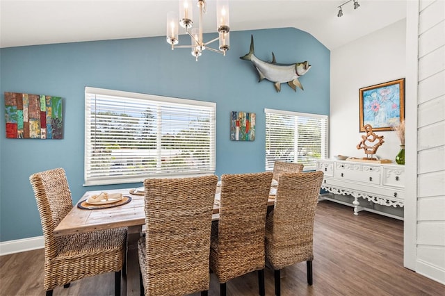 1210 Bay Pine Blvd, Indian Rocks Beach, FL 33785 - dining space with a chandelier, wood finished floors, high vaulted ceiling, and baseboards