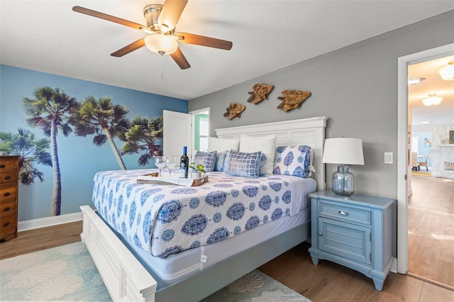 1210 Bay Pine Blvd, Indian Rocks Beach, FL 33785 - bedroom with wood finished floors, ceiling fan, and baseboards
