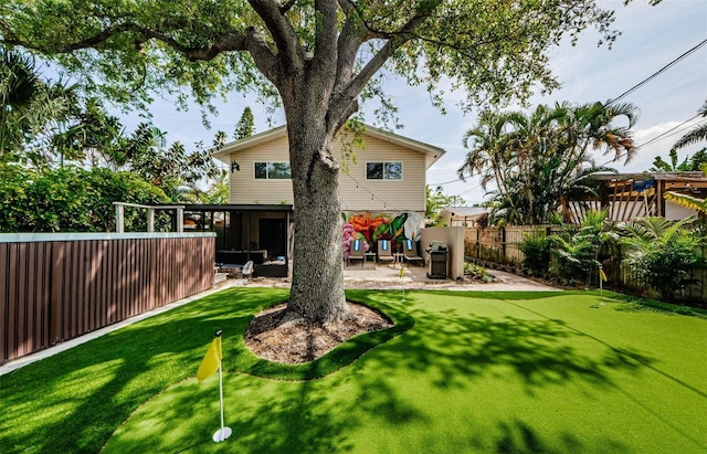 1210 Bay Pine Blvd, Indian Rocks Beach, FL 33785 - back of property with a putting green, a patio area, and a fenced backyard