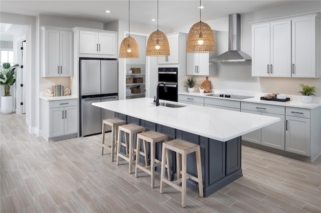 17420 Moonflower Dr Unit 201, Venice, FL 34293 - kitchen with black appliances, wall chimney exhaust hood, a sink, recessed lighting, and light wood-style floors
