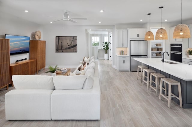 17420 Moonflower Dr Unit 201, Venice, FL 34293 - living room with a ceiling fan, recessed lighting, and light wood-style flooring