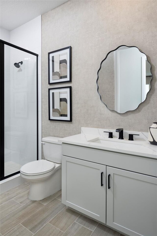 17420 Moonflower Dr Unit 201, Venice, FL 34293 - full bathroom with a stall shower, toilet, and vanity