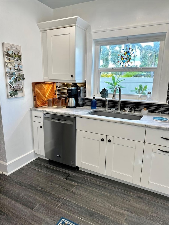 1020 38th Ave N, Saint Petersburg, FL 33704 - kitchen with dishwasher, a sink, backsplash, and white cabinets