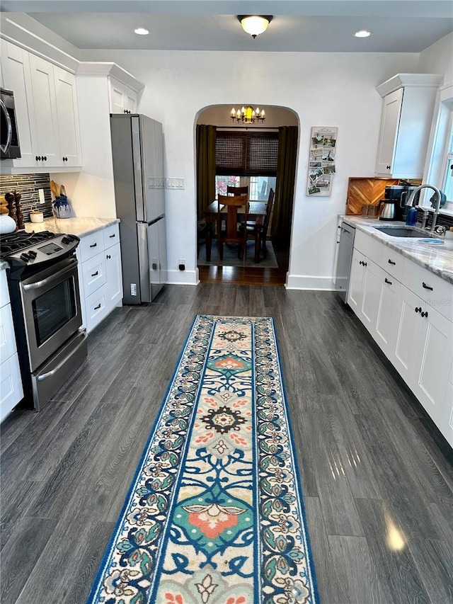 1020 38th Ave N, Saint Petersburg, FL 33704 - kitchen with appliances with stainless steel finishes, arched walkways, a sink, recessed lighting, and white cabinetry