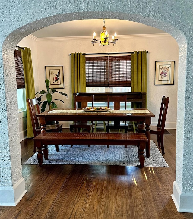 1020 38th Ave N, Saint Petersburg, FL 33704 - dining space with arched walkways, a chandelier, a textured wall, ornamental molding, and baseboards