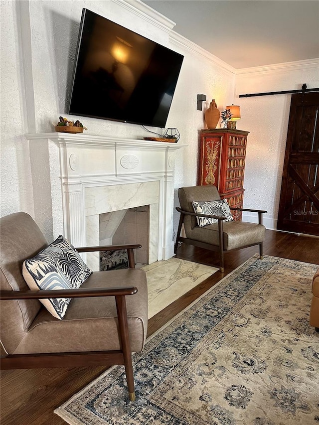1020 38th Ave N, Saint Petersburg, FL 33704 - living room with a barn door, a textured wall, a fireplace, wood finished floors, and ornamental molding