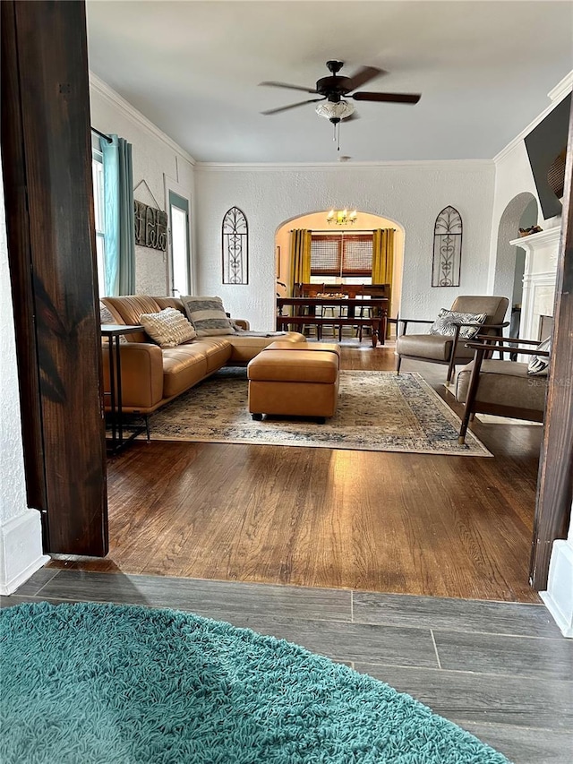 1020 38th Ave N, Saint Petersburg, FL 33704 - living area with arched walkways, crown molding, a ceiling fan, wood finished floors, and a textured wall