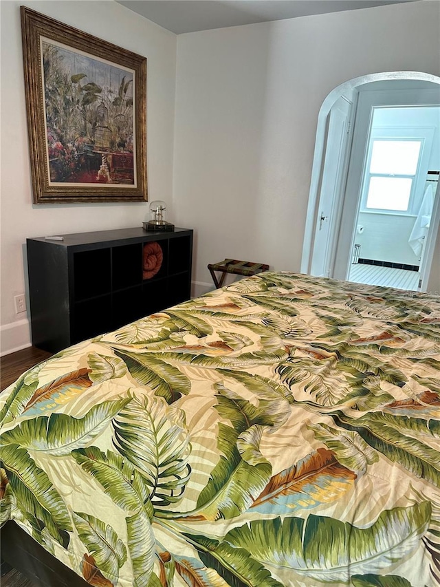 1020 38th Ave N, Saint Petersburg, FL 33704 - bedroom with arched walkways and wood finished floors