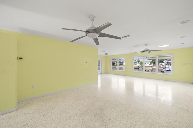 3932 Shore Acres Blvd NE, Saint Petersburg, FL 33703 - empty room with ceiling fan, speckle patterned floor, and baseboards