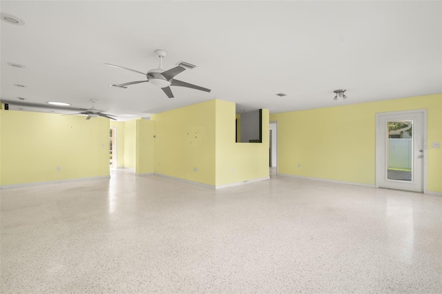 3932 Shore Acres Blvd NE, Saint Petersburg, FL 33703 - empty room featuring dark aggregate flooring, ceiling fan, and baseboards
